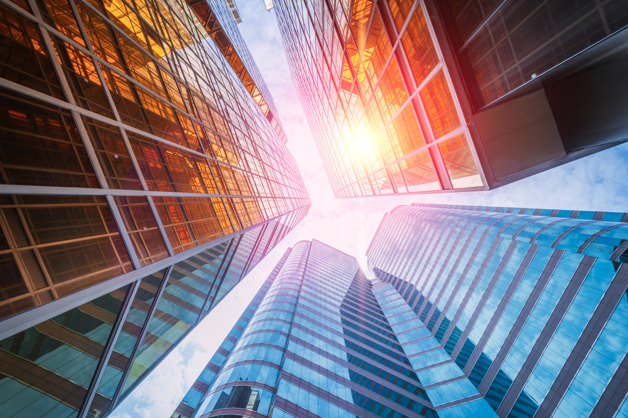 sun shining among skyscrapers