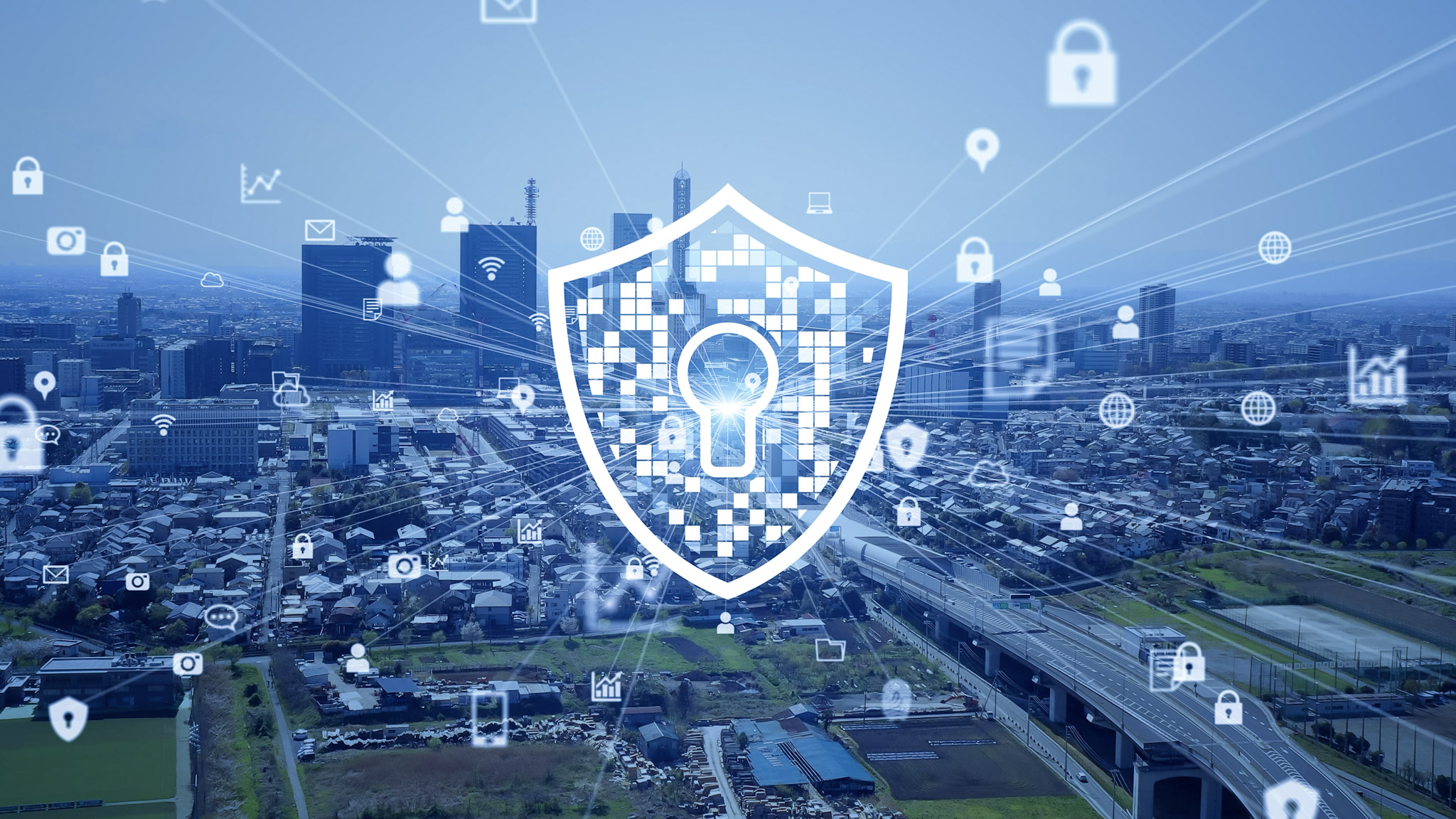 A digital shield with a keyhole symbol overlays a cityscape, surrounded by icons representing security