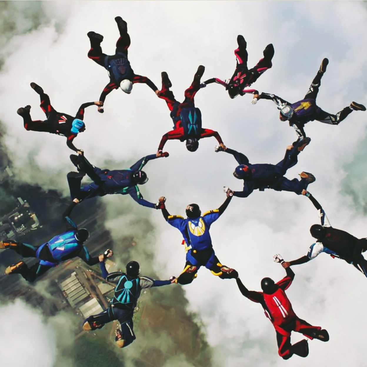 Group of skydivers holding hands