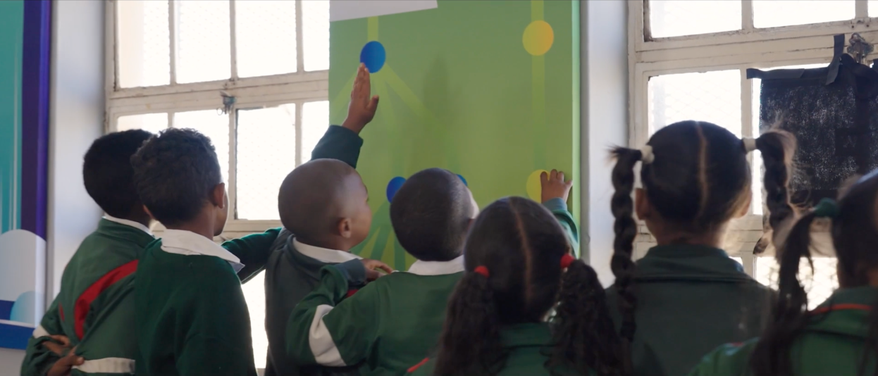 Children admiring and touching artwork.