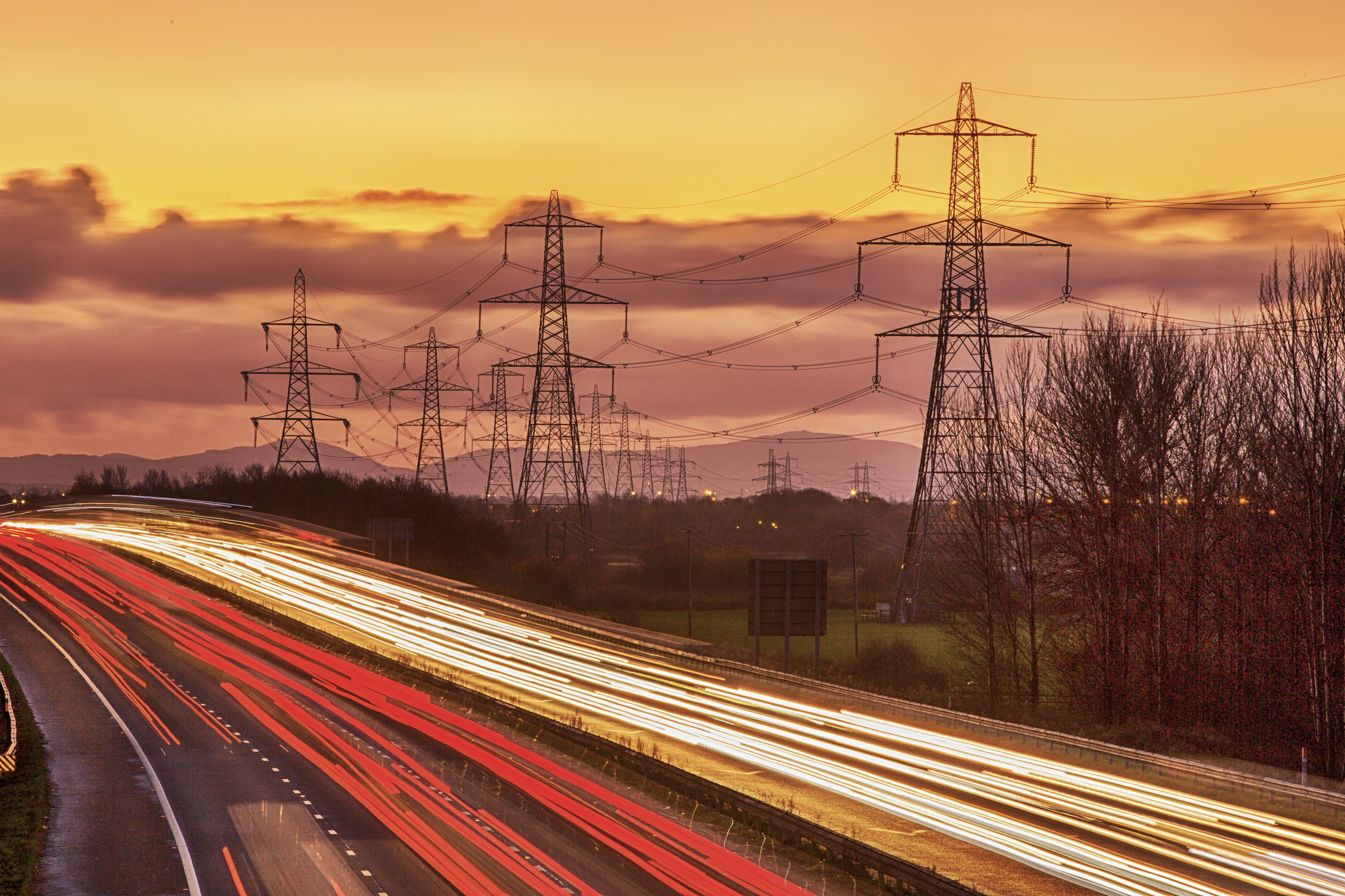 Rushhour on the M56 motorway near Helsby, Cheshire, UK at dusk.