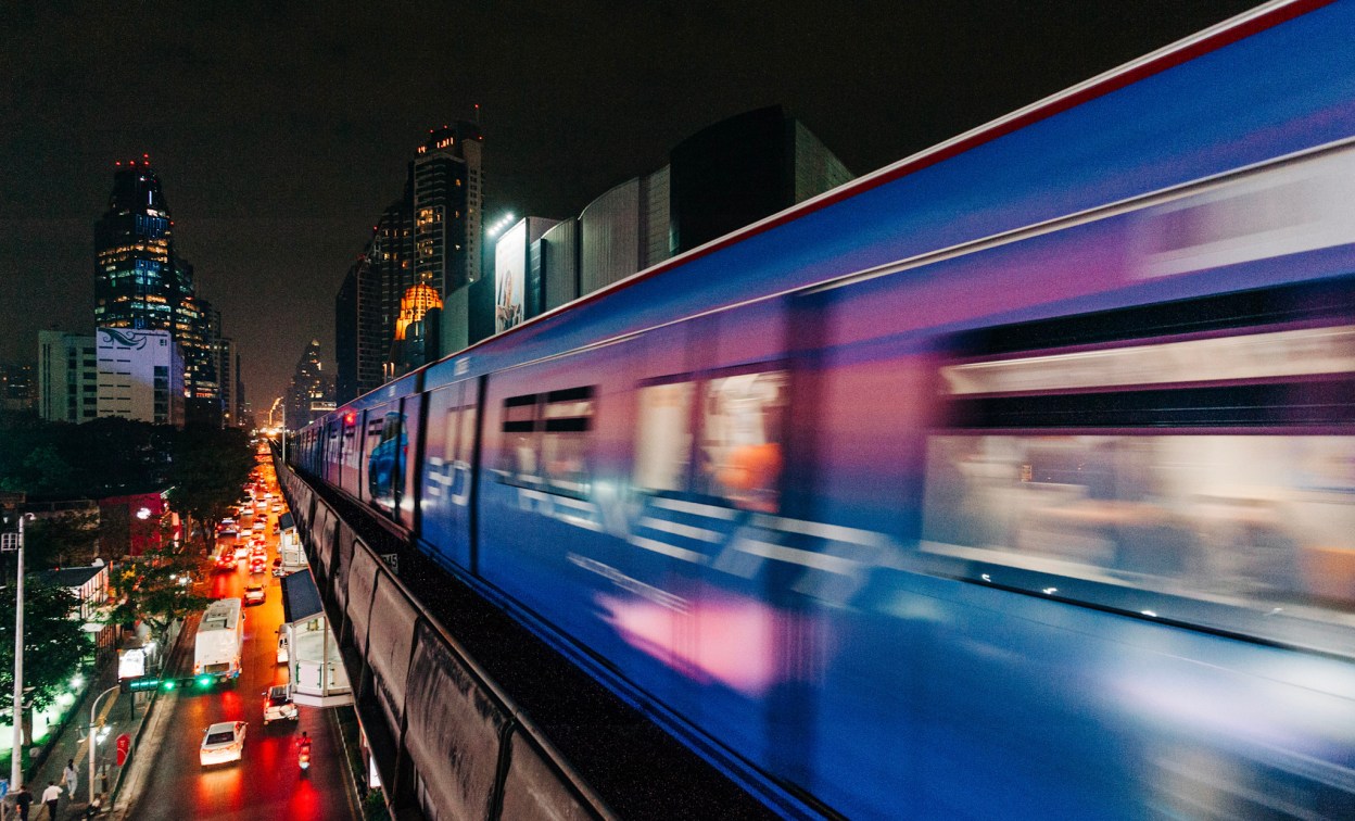 Modern train moving through a major Asia Pacific city at night, representing digital transformation and market growth in the APJ region