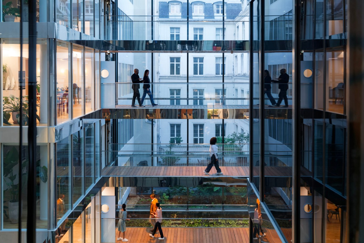 Professionals walking through a modern office building, representing the Broadcom Knights program and technical expertise in enterprise infrastructure and VMware Cloud Foundation.