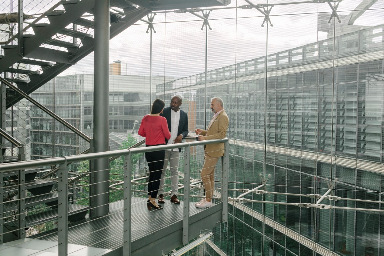 Business leaders meeting in a modern office building, representing enterprise modernization, private cloud adoption, and AI transformation across Asia Pacific and the Middle East.