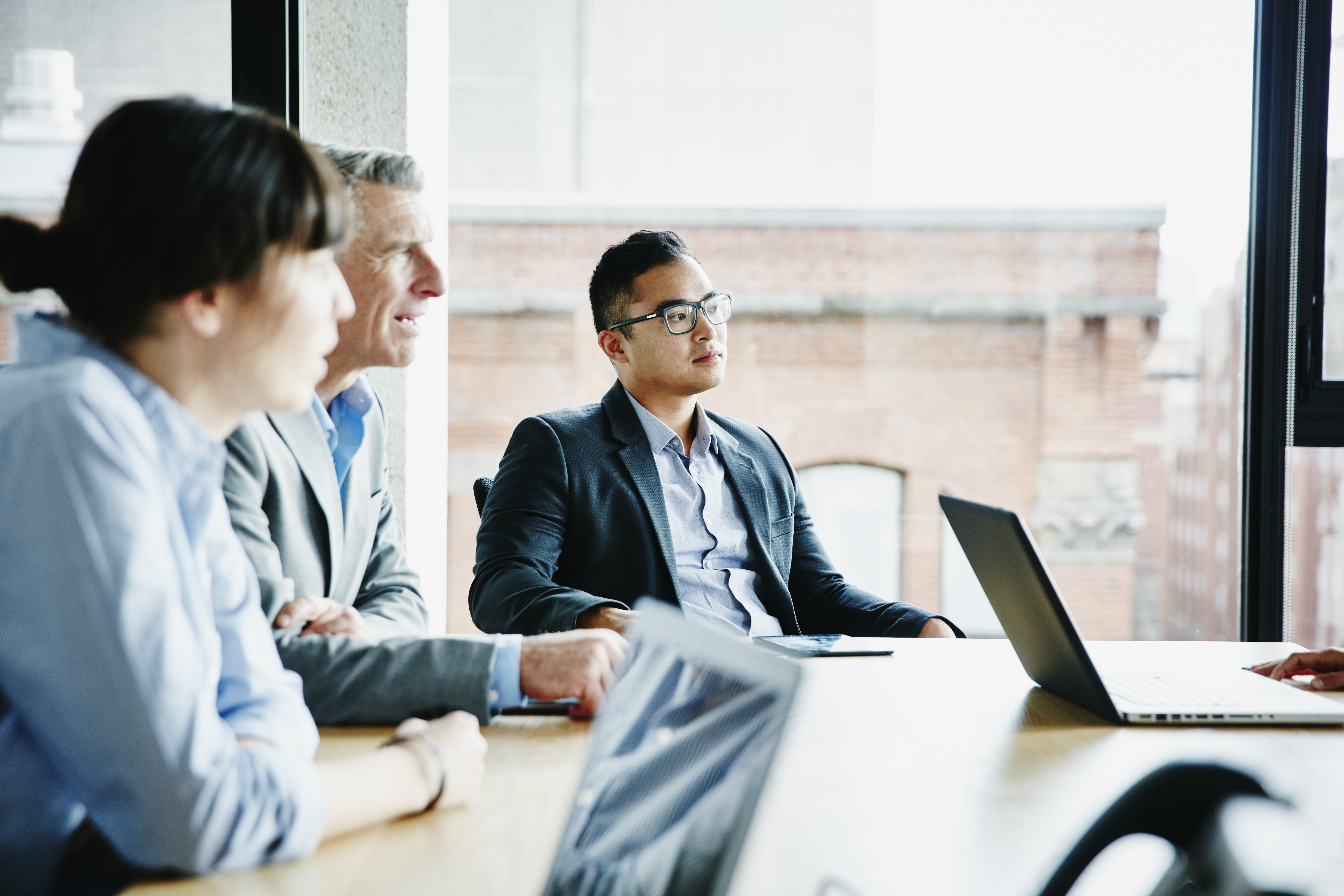 Businessman listening to presentation during project meeting in office