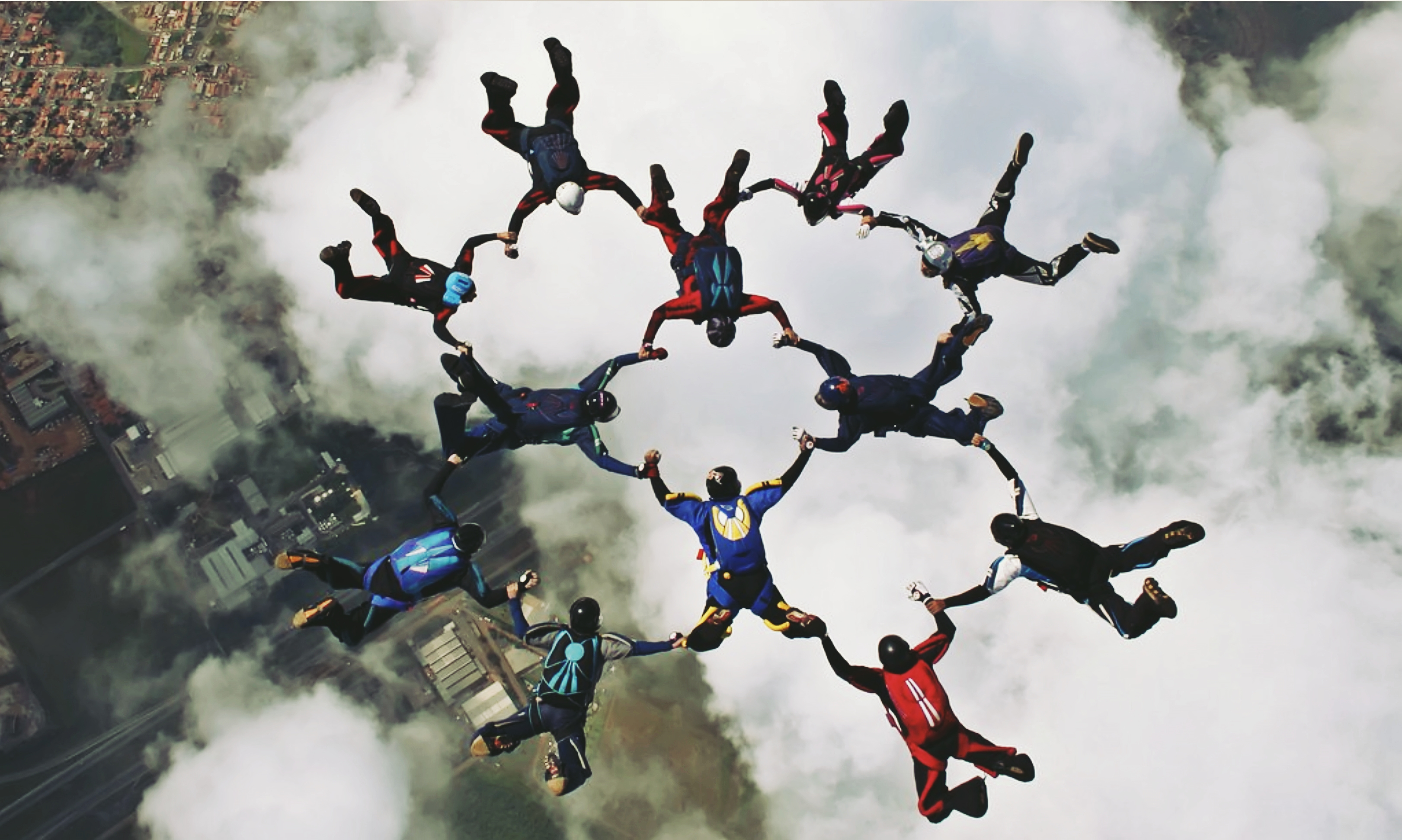 Group of skydivers holding hands