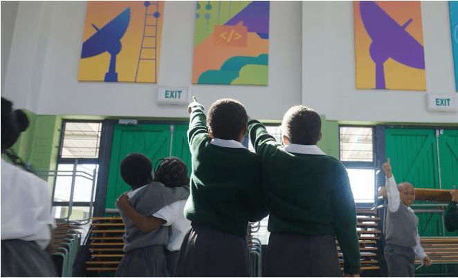 Students pointing at the colorful artwork