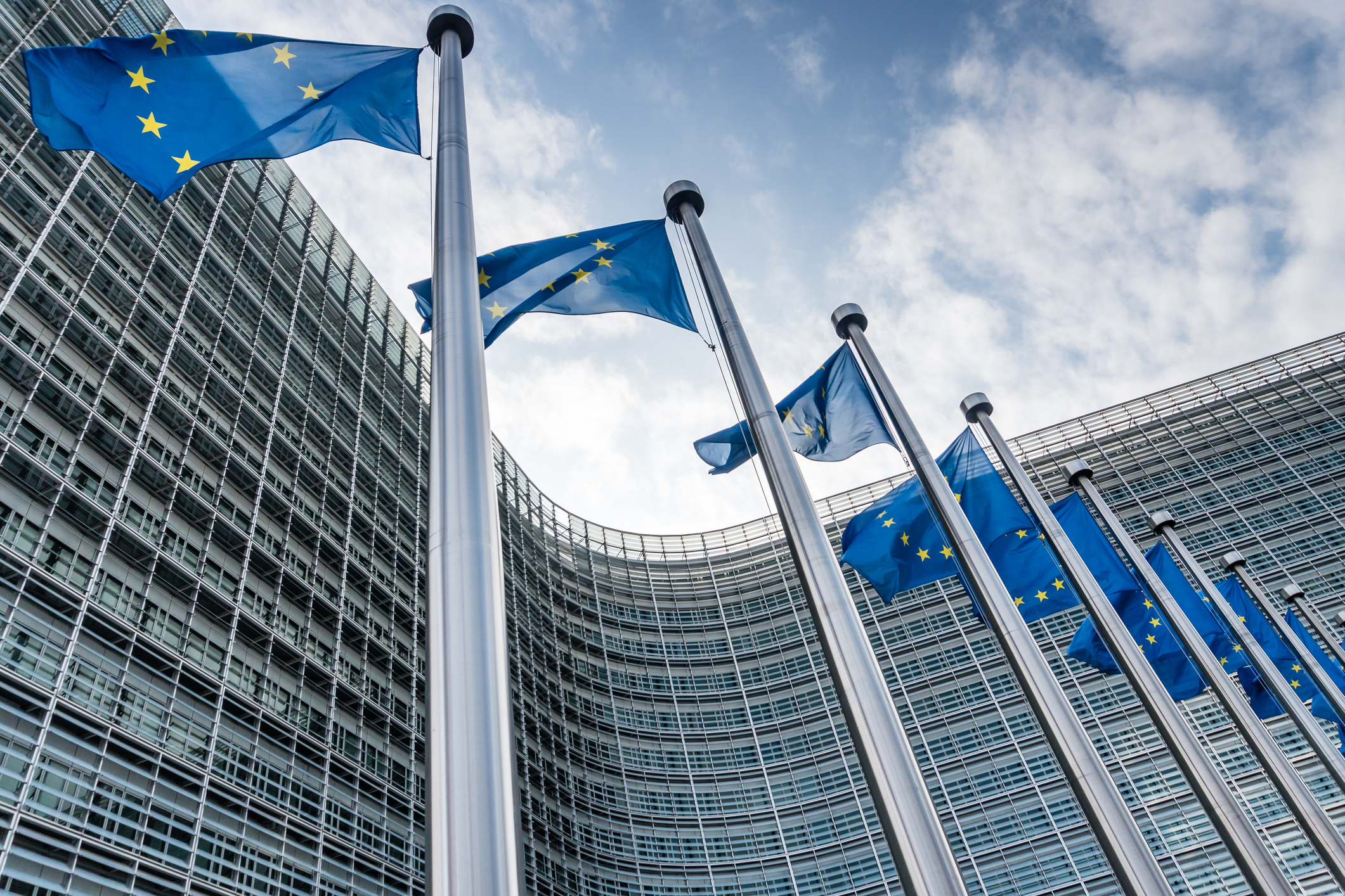 European Union flags waiving at Berlaymont building of the European Commission in Brussels, Belgium