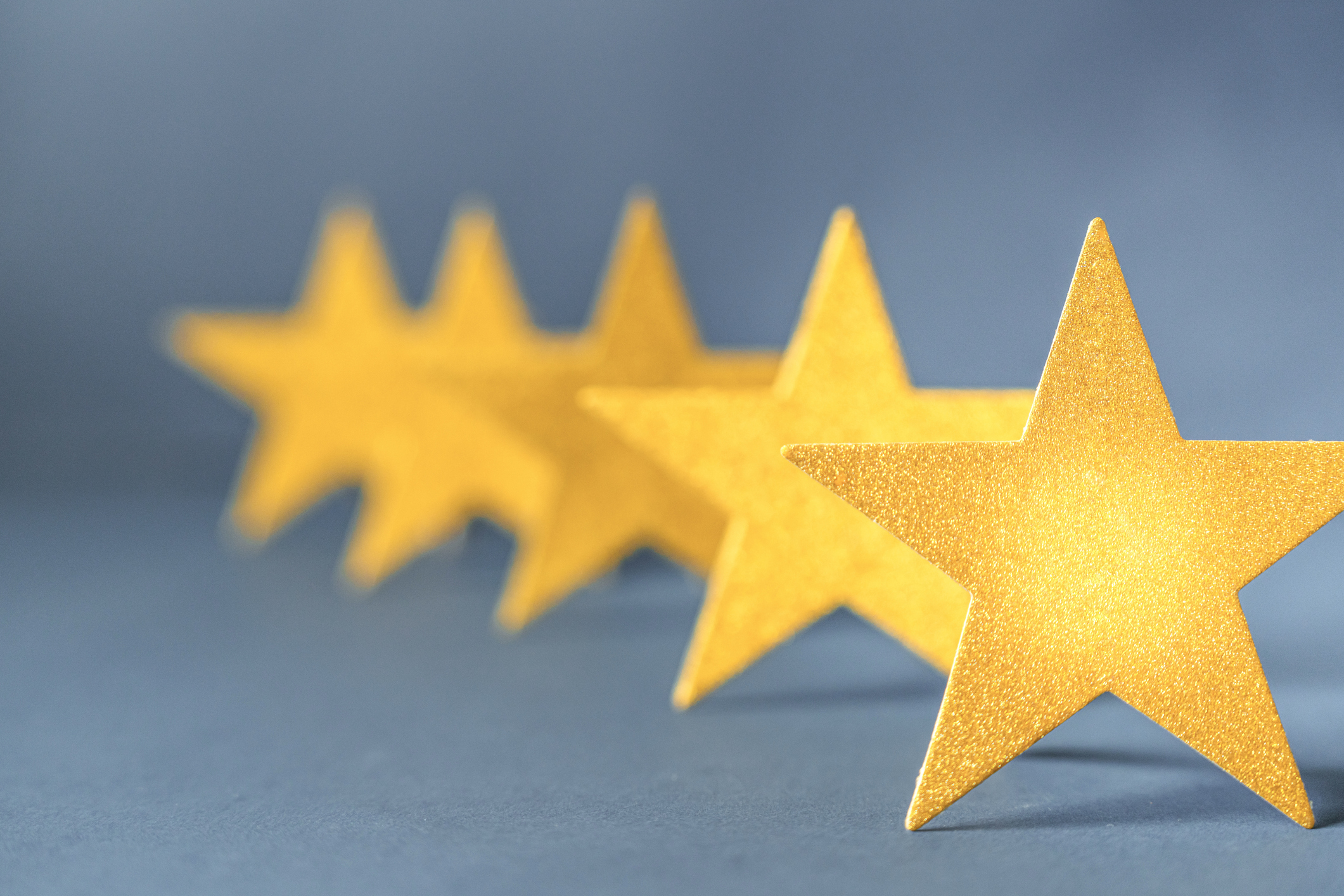 Gold stars aligned at an angle with a blue background to recognize Broadcom Partner Awards.