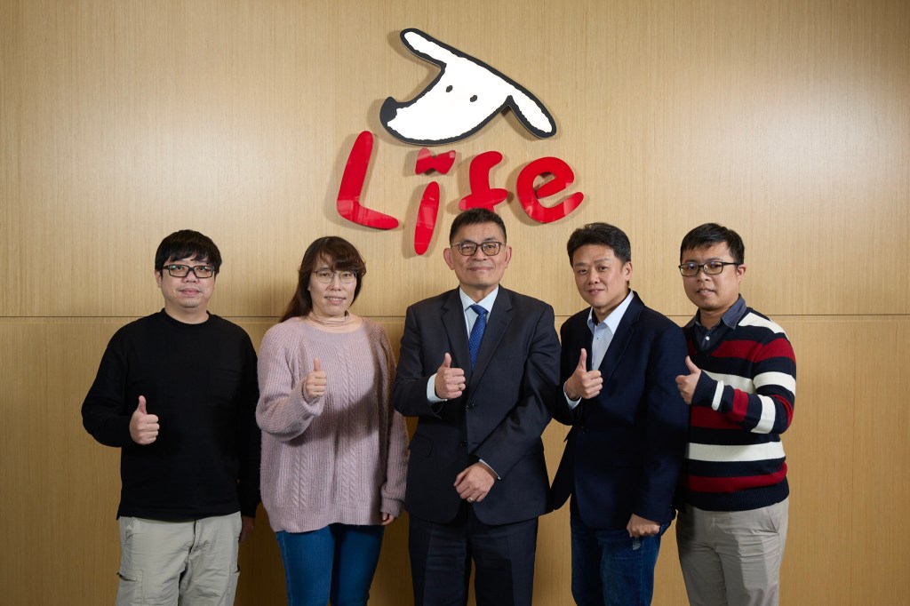 Taishin Bank team in front of logo