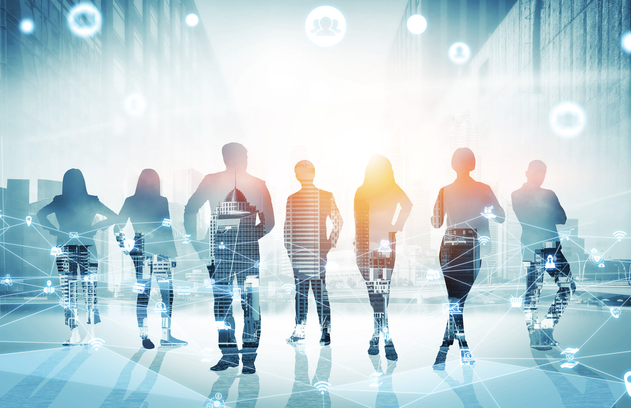 Silhouettes of business team with digital network overlay.