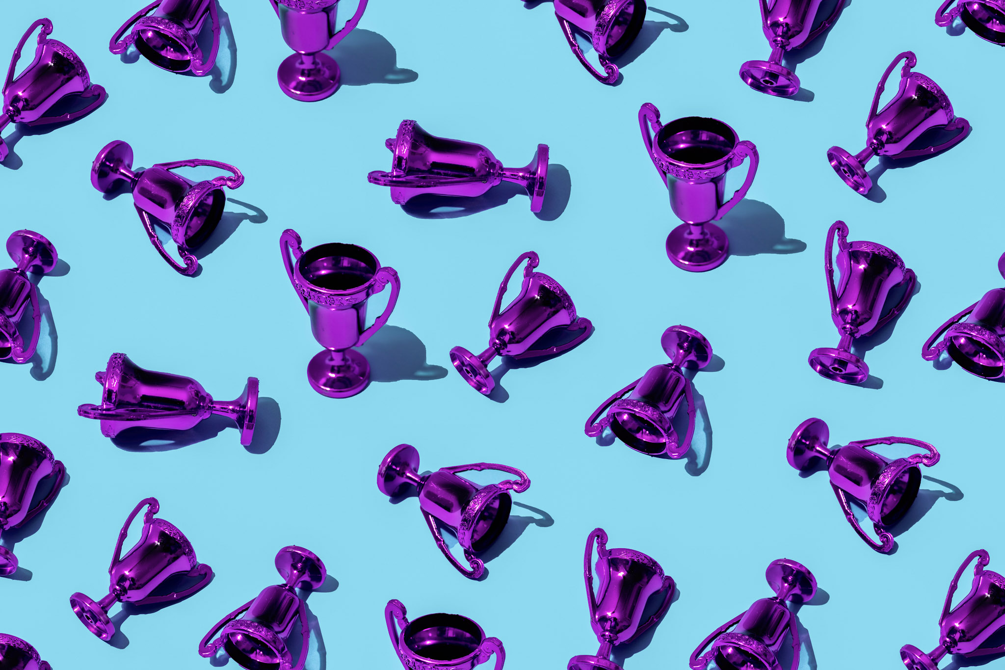 Pattern of purple trophies on a blue background symbolizing the Broadcom 2025 VMware Cloud Service Provider Partner Awards and global partner recognition.