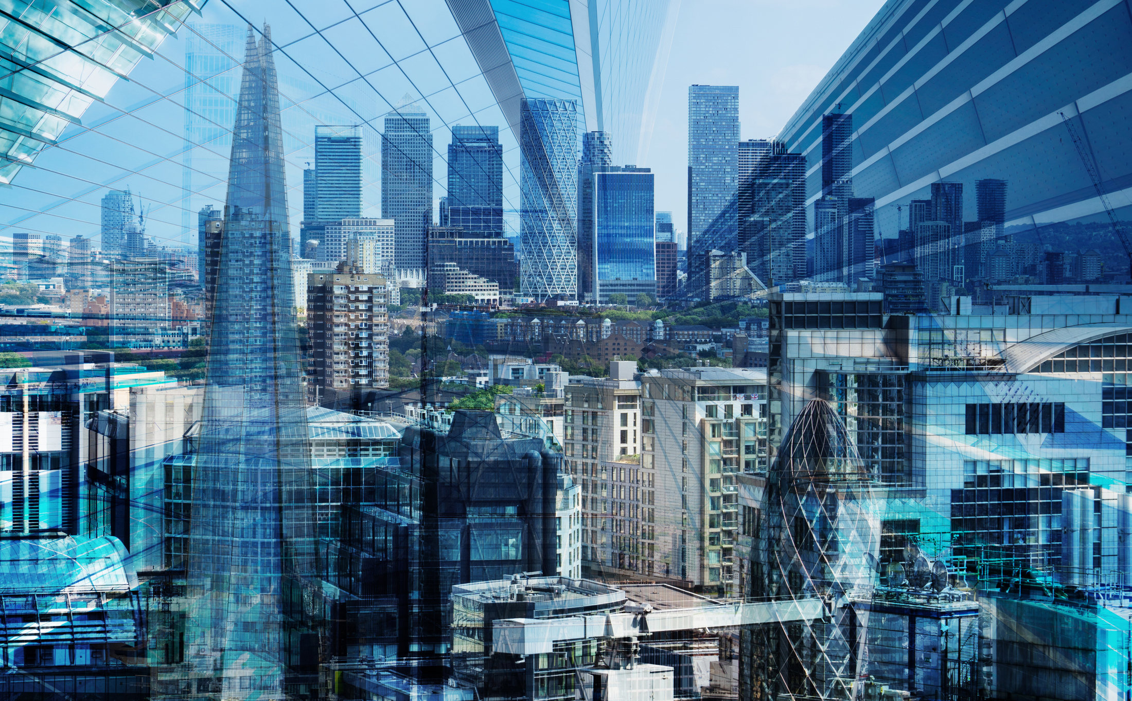 Modern city skyline with layered digital grid overlays representing cloud infrastructure, data center modernization, and connected enterprise technology.