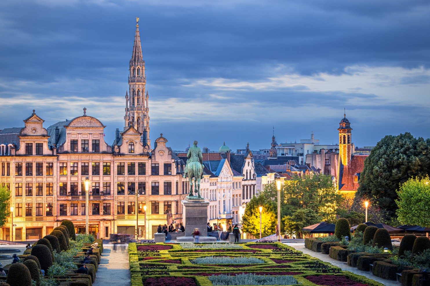 Evening view of Brussels cityscape with Mont des Arts gardens, equestrian statue, and historic buildings, representing European digital policy