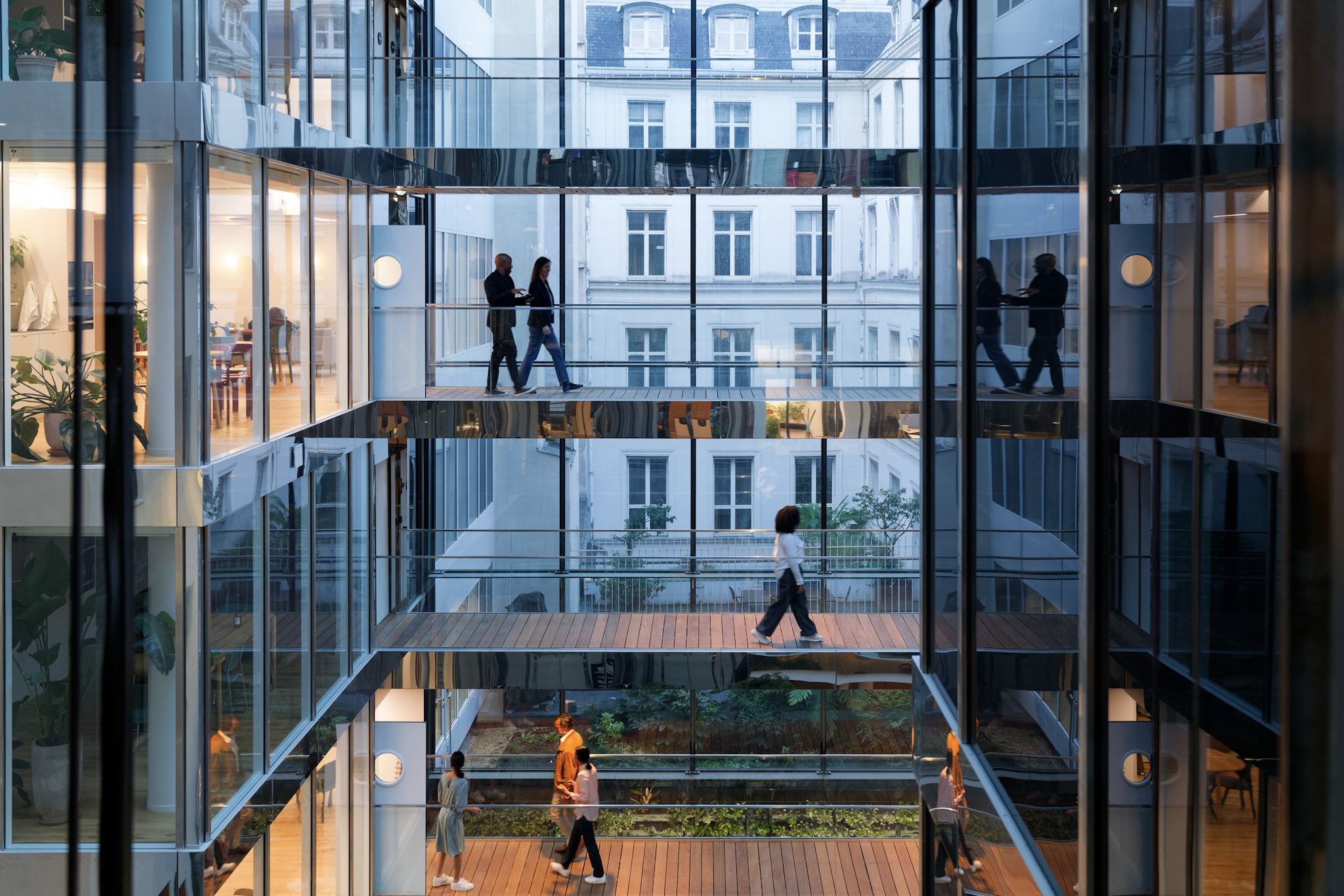 Professionals walking through a modern office building, representing the Broadcom Knights program and technical expertise in enterprise infrastructure and VMware Cloud Foundation.