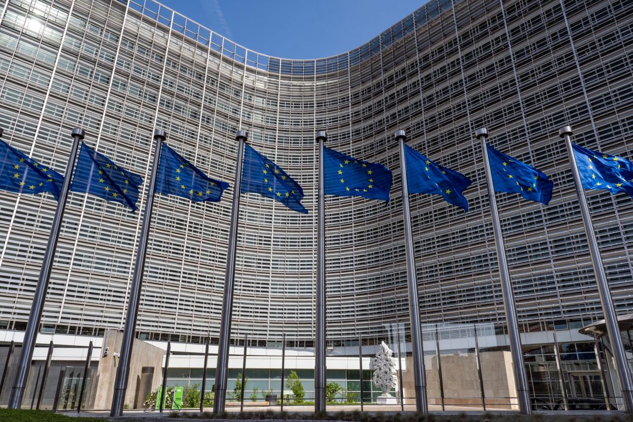 Row of European Union flags flying in front of the Berlaymont building in Brussels, EU headquarters